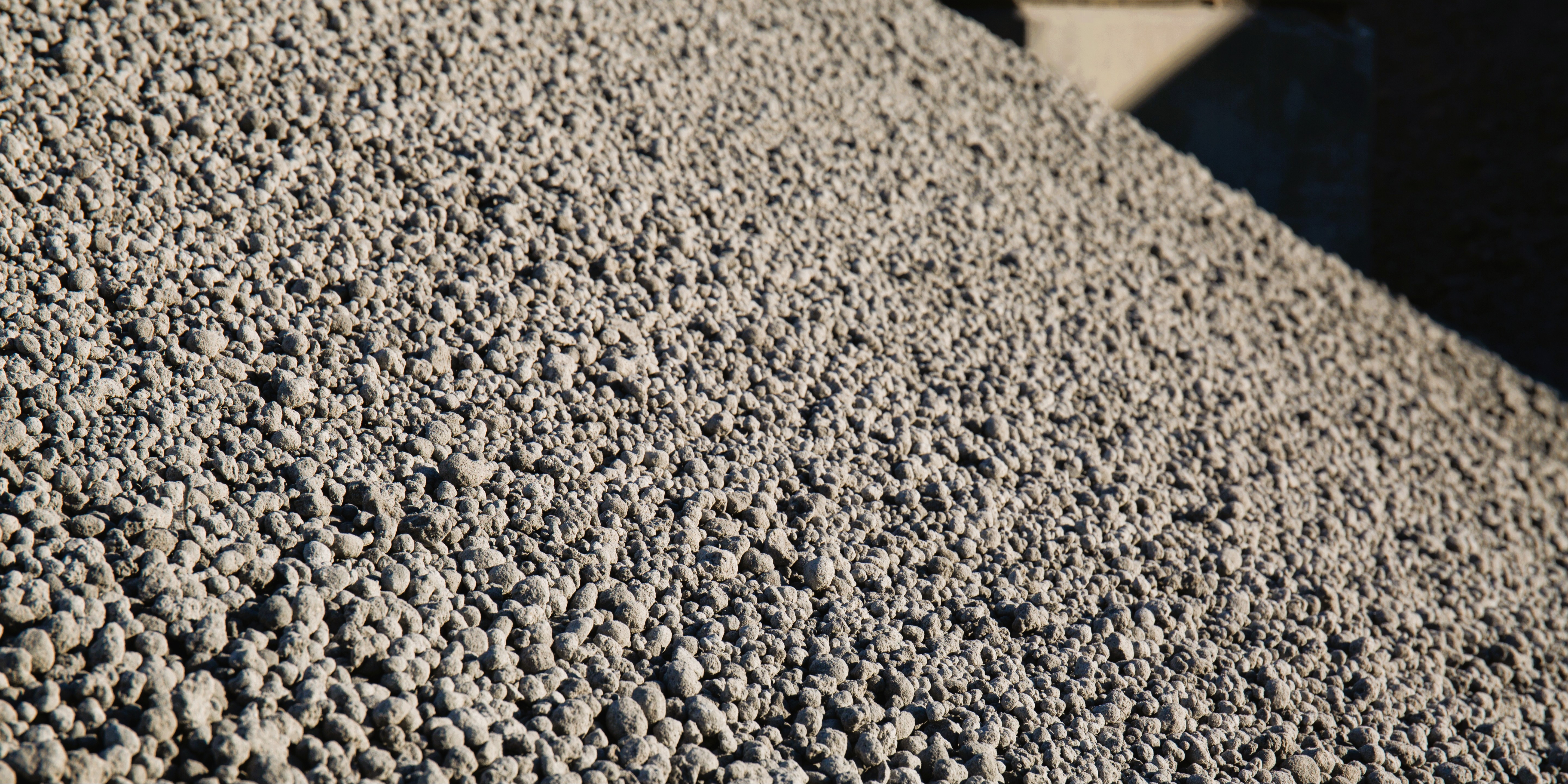 A close-up view of a pile of gravel or aggregate material with a rough texture and various sizes of stones.
